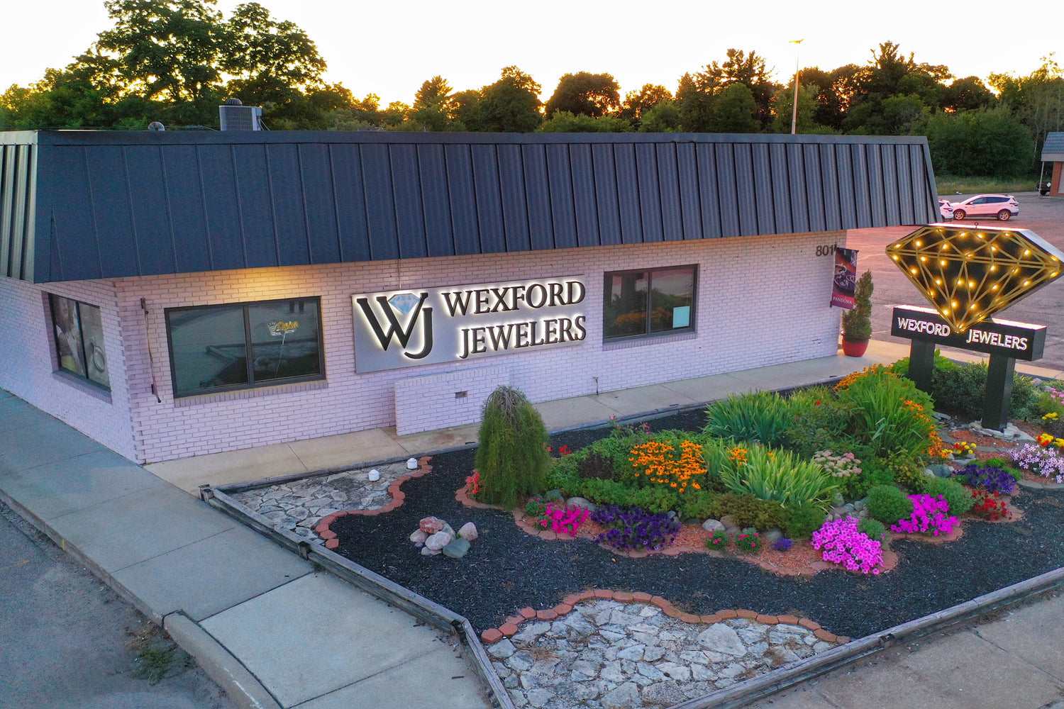 Aerial view of Northern Michigan landmark jewelry store Wexford Jewelers, in full summer bloom