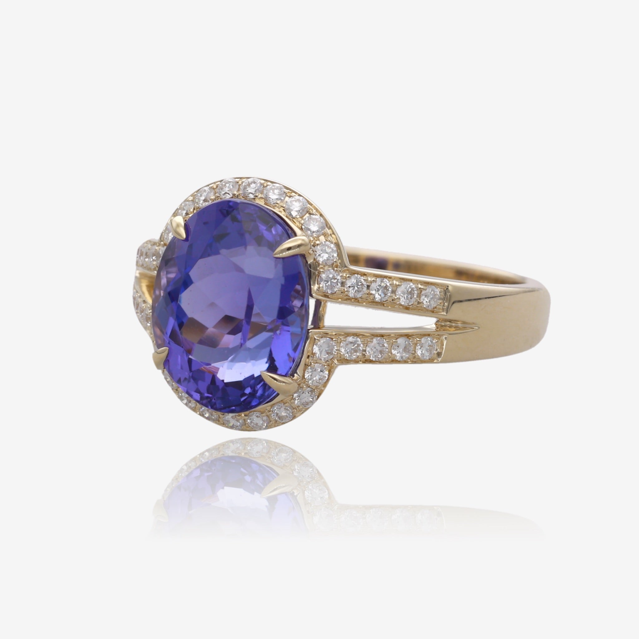 Royal Radiance: Yellow Gold Oval Tanzanite Ring with Diamond Accents