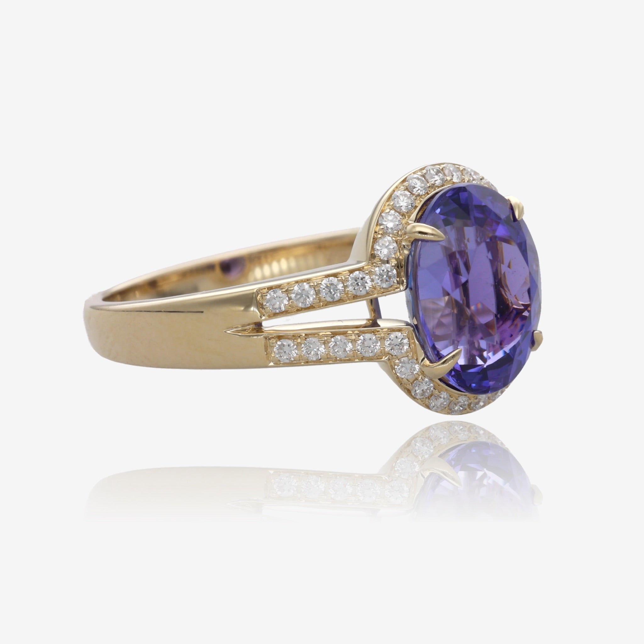 Royal Radiance: Yellow Gold Oval Tanzanite Ring with Diamond Accents