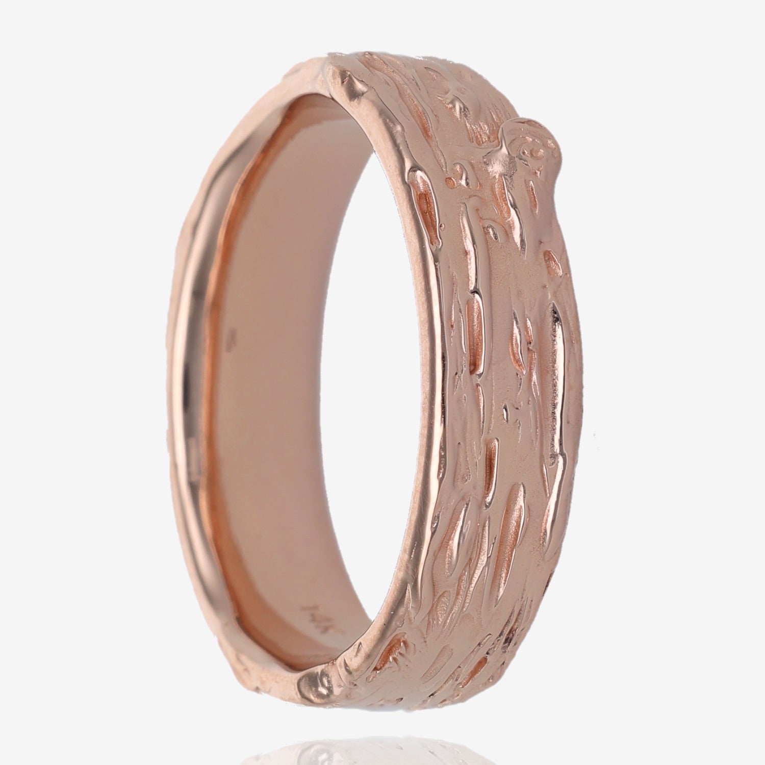 Side view of rose gold wedding band 1/4” wide, with raised and recessed lines resembling birch bark. Texture includes knots and divots and slight rough areas.