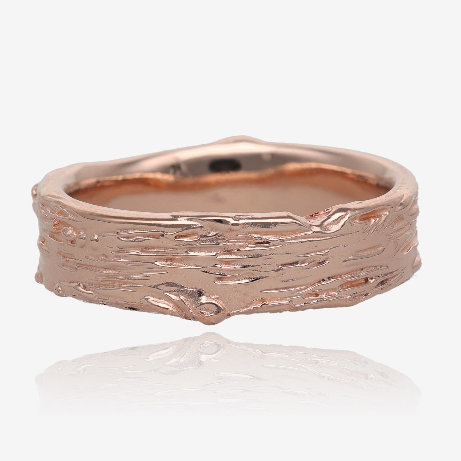 Image shows pink gold band 6mm wide, with raised and recessed lines resembling birch bark. Texture includes knots and divots and slight rough areas.