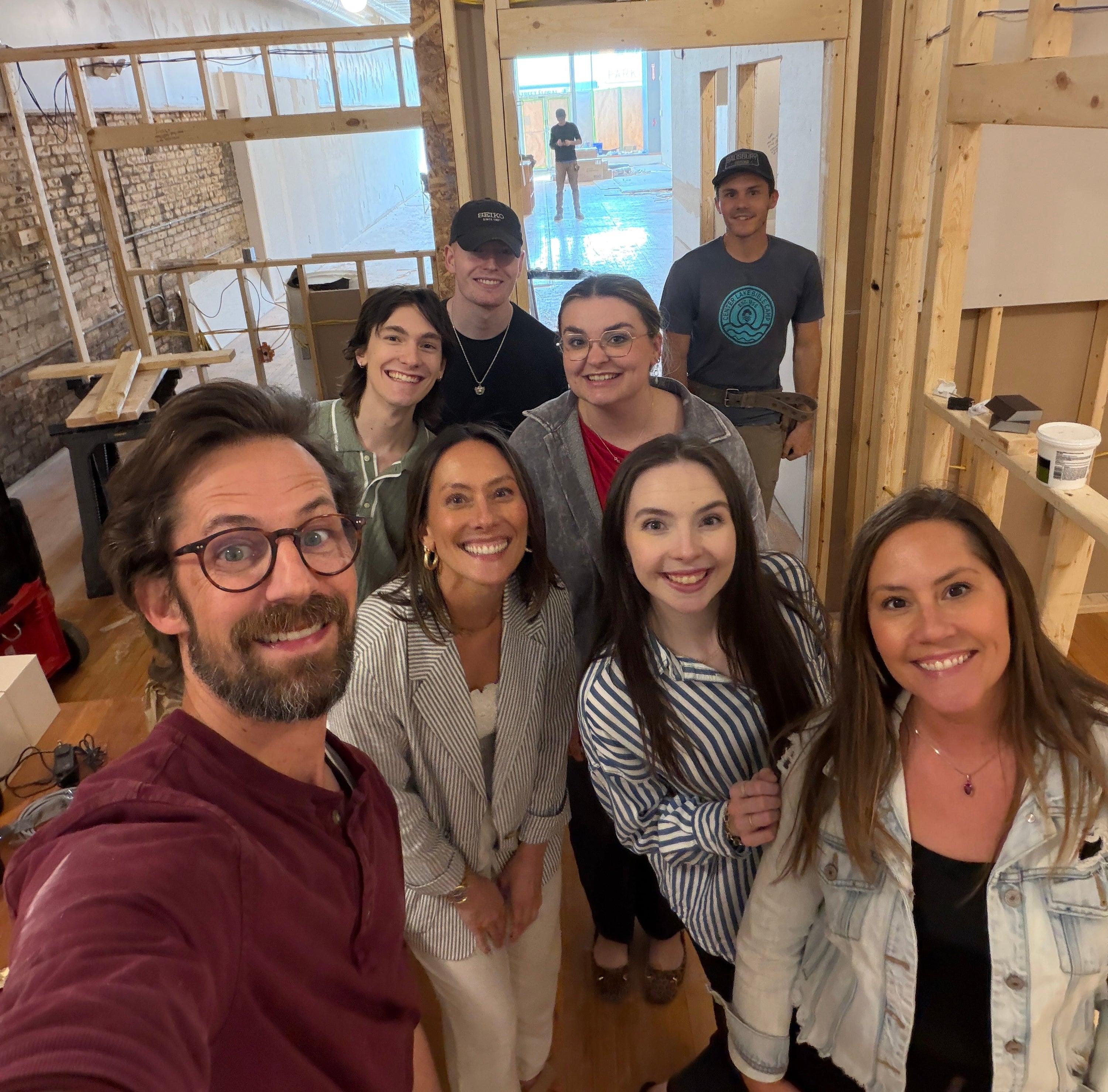 the WJ team standing in an empty room