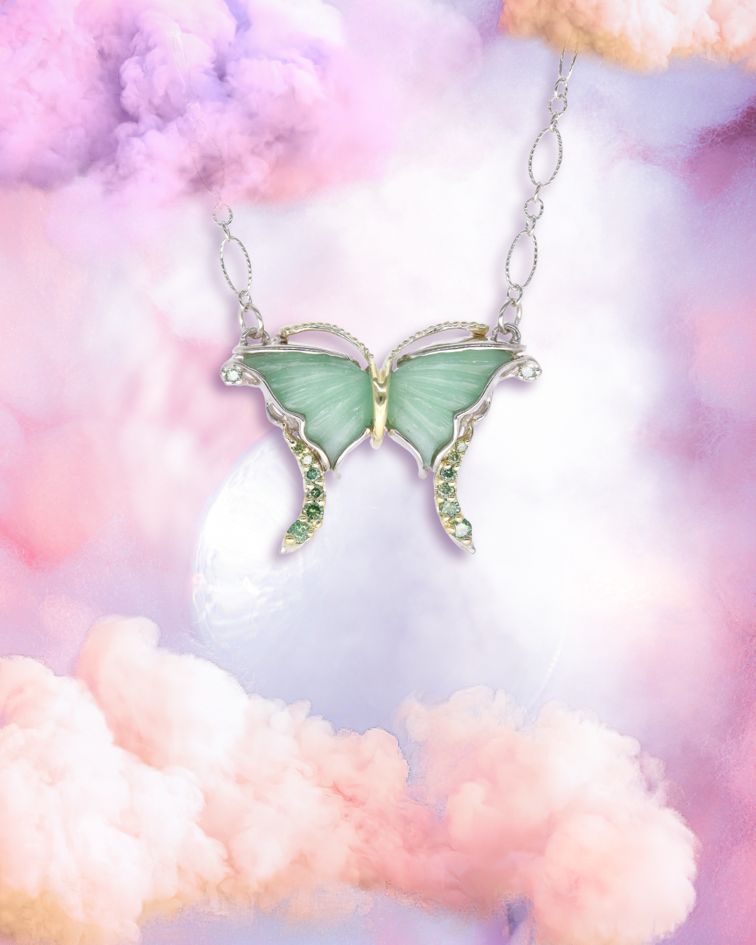 green winged butterfly necklace floats above a pink and peach cloud sunset
