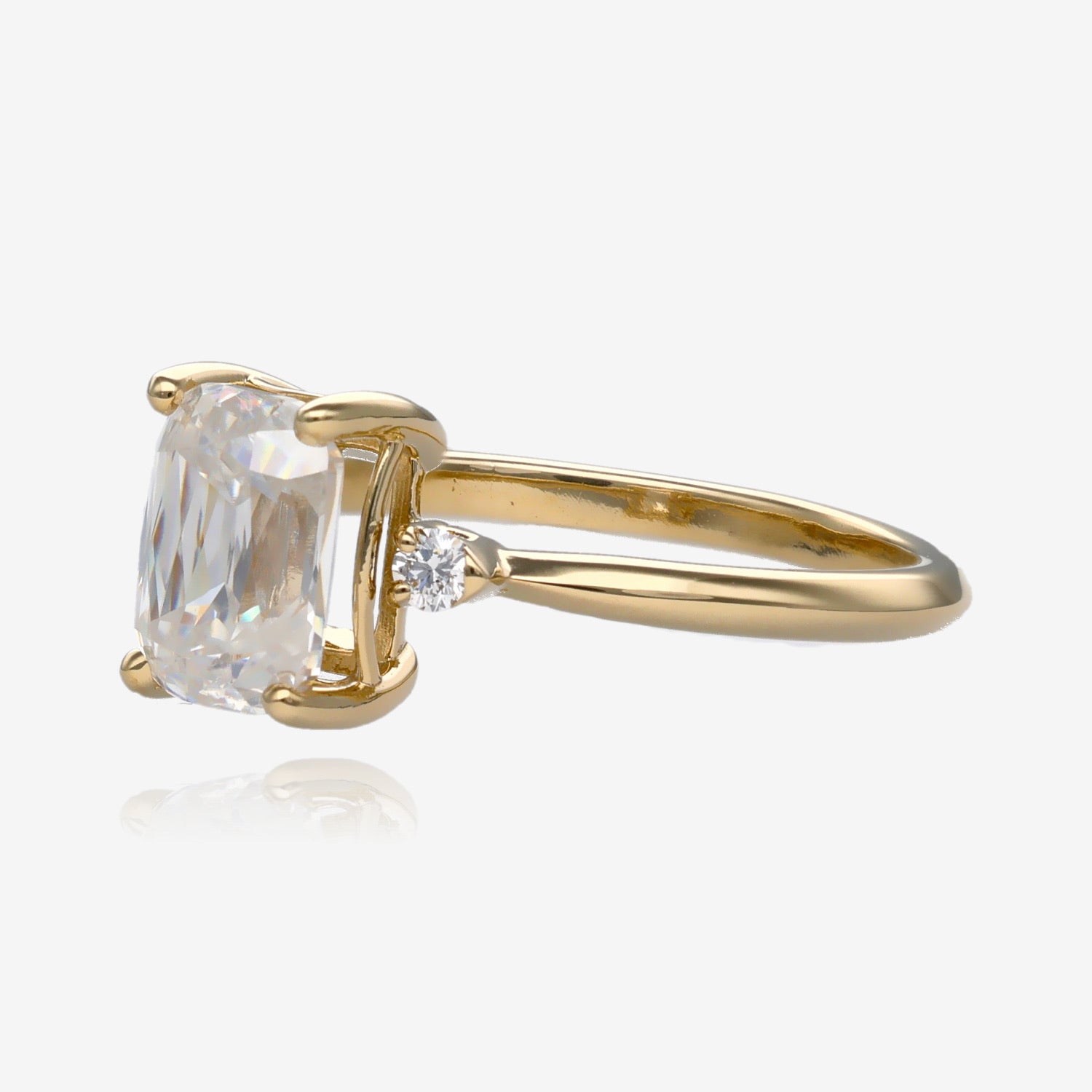 Side view Ring, scissor cut, cushion shape moissanite in a slender yellow gold band with a small diamond on each side 