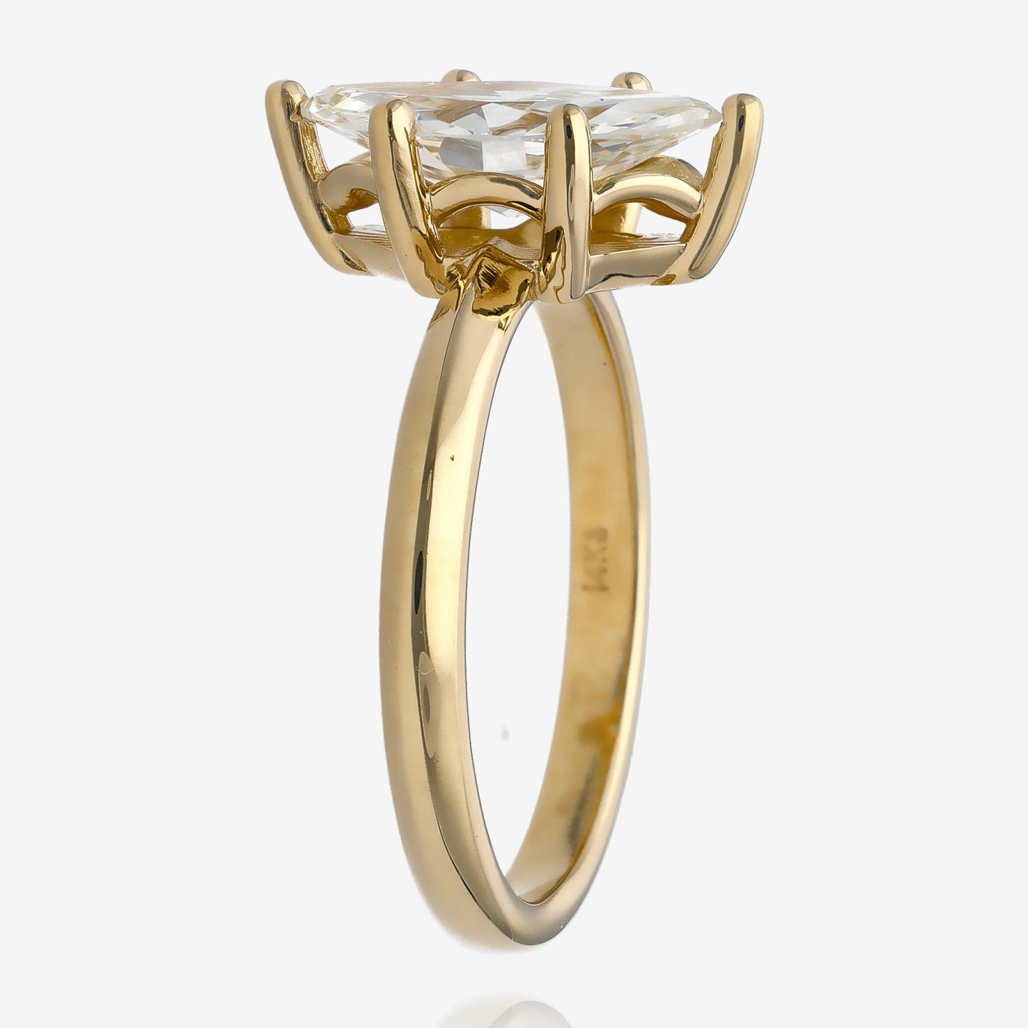 Side view of large diamond cut in a marquise shape. It is set in a yellow gold solitaire with small arches between prongs