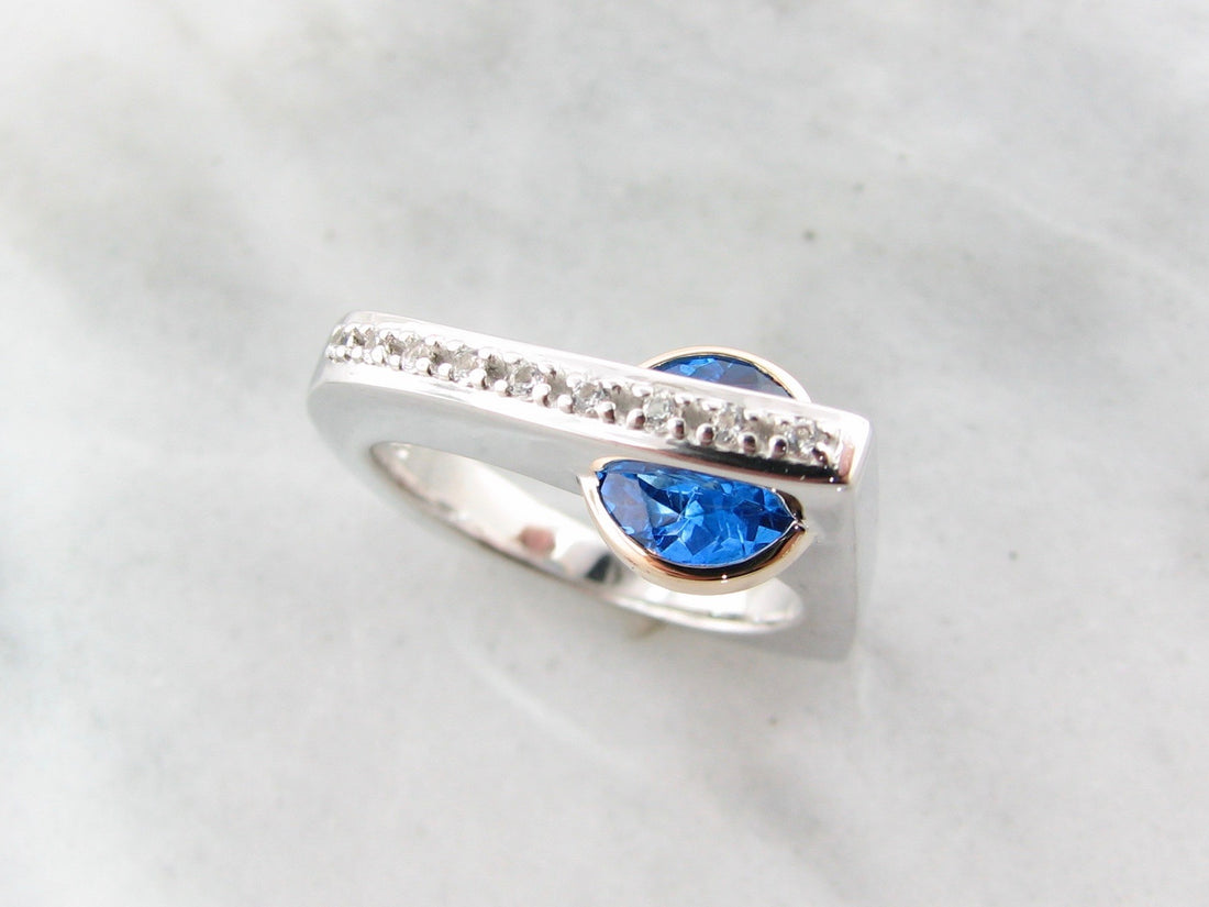 Blue topaz ring in sterling silver with topaz and white sapphire with 14k yellow gold.