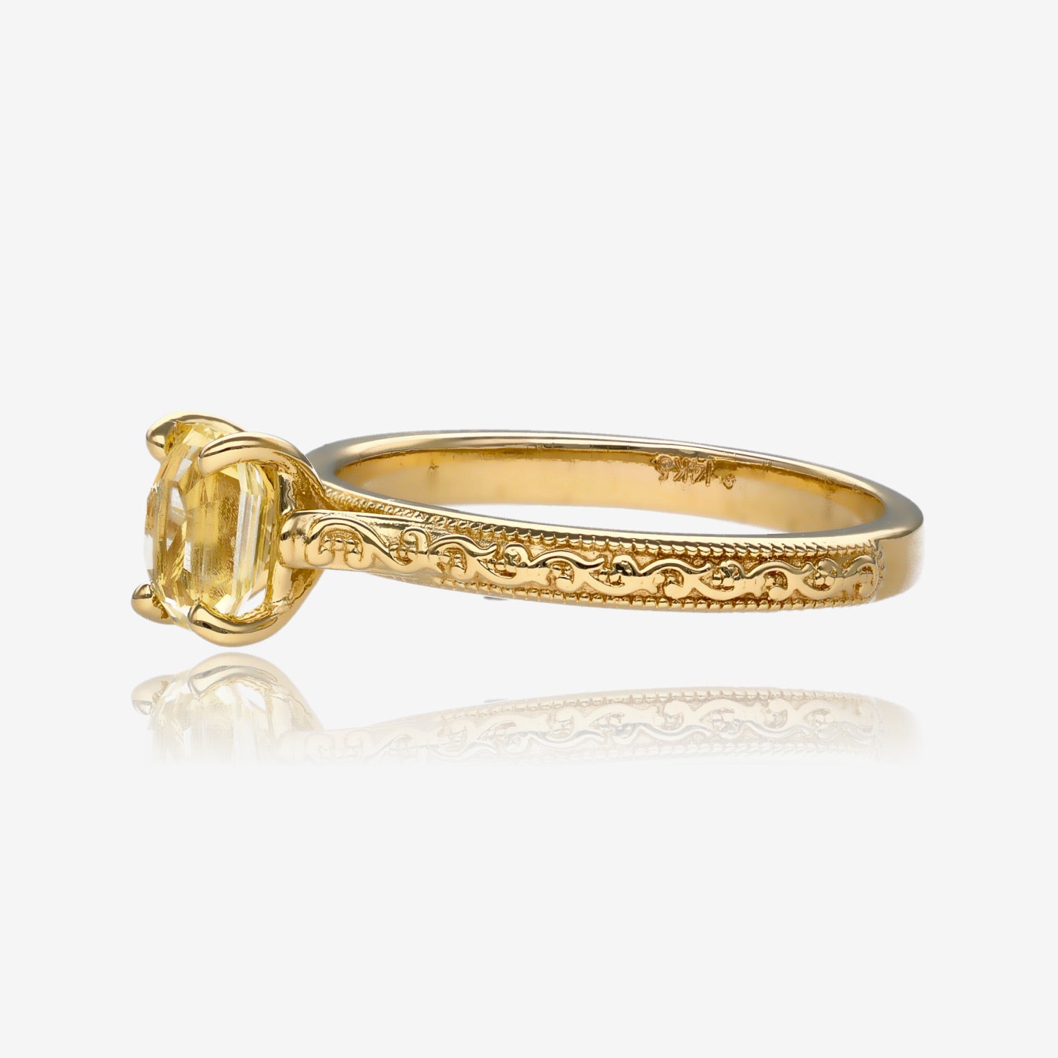 Sideview of yellow gold engagement ring with yellow gemstone set above the band. Ring has vintage detailing down the side.