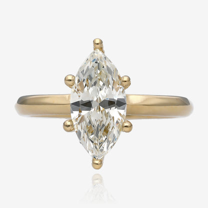 One and a half carat marquise diamond set lengthwise in a six prong yellow gold solitaire 