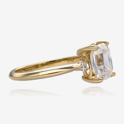 Side view Ring, scissor cut, cushion shape moissanite in a slender yellow gold band with a small diamond on each side 