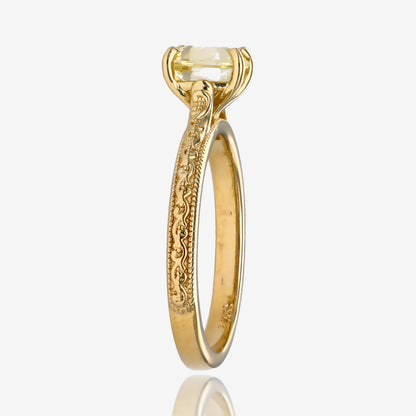 Sideview of yellow gold engagement ring with yellow gemstone set above the band. Ring has vintage detailing down the side.