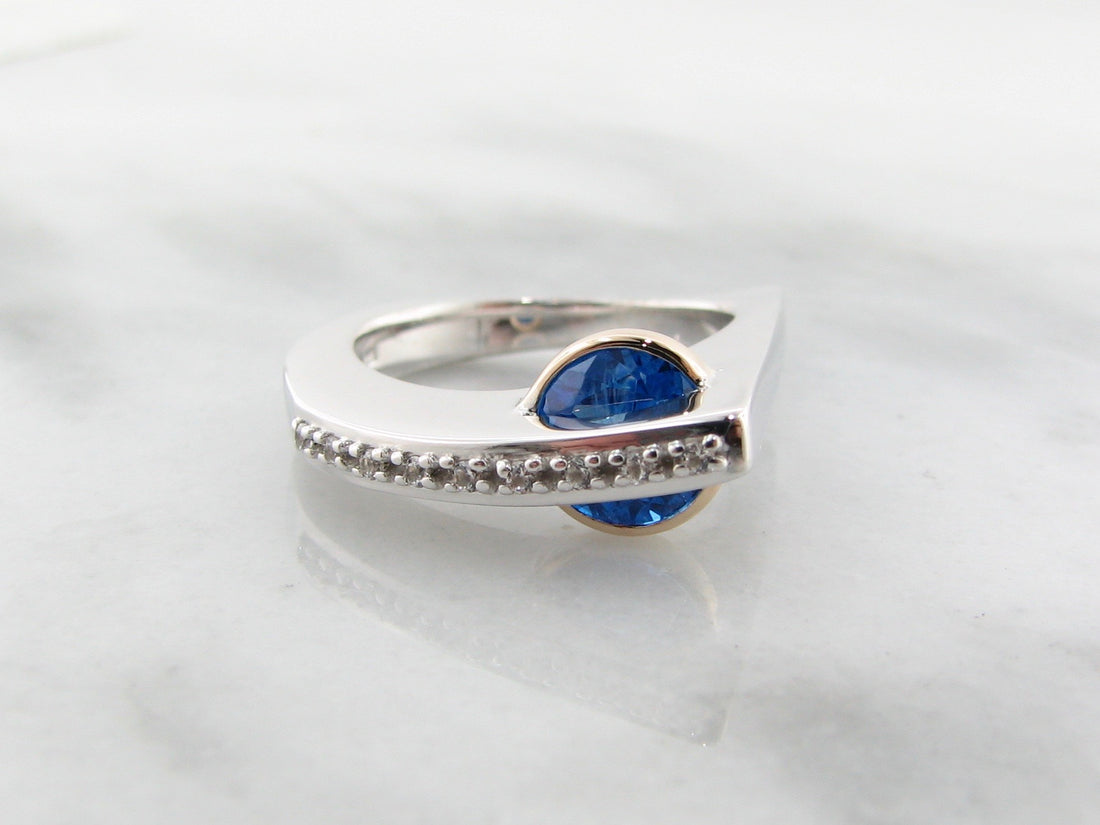 Blue topaz ring in sterling silver with topaz and white sapphire with 14k yellow gold.