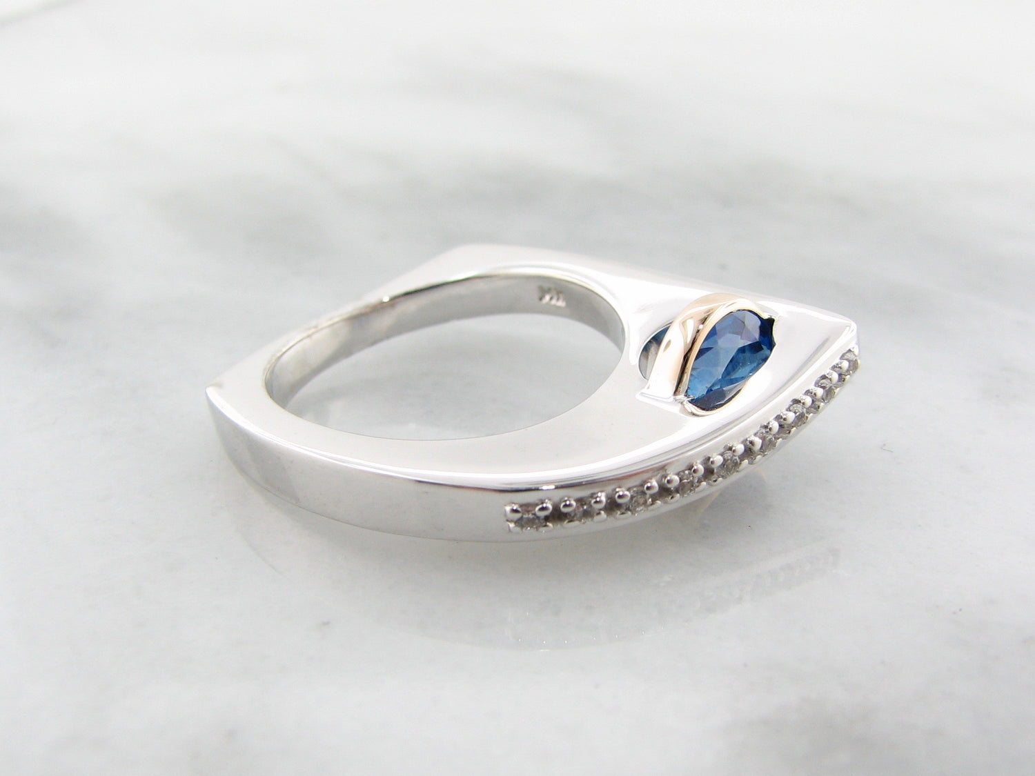 Blue topaz ring in sterling silver with topaz and white sapphire with 14k yellow gold.