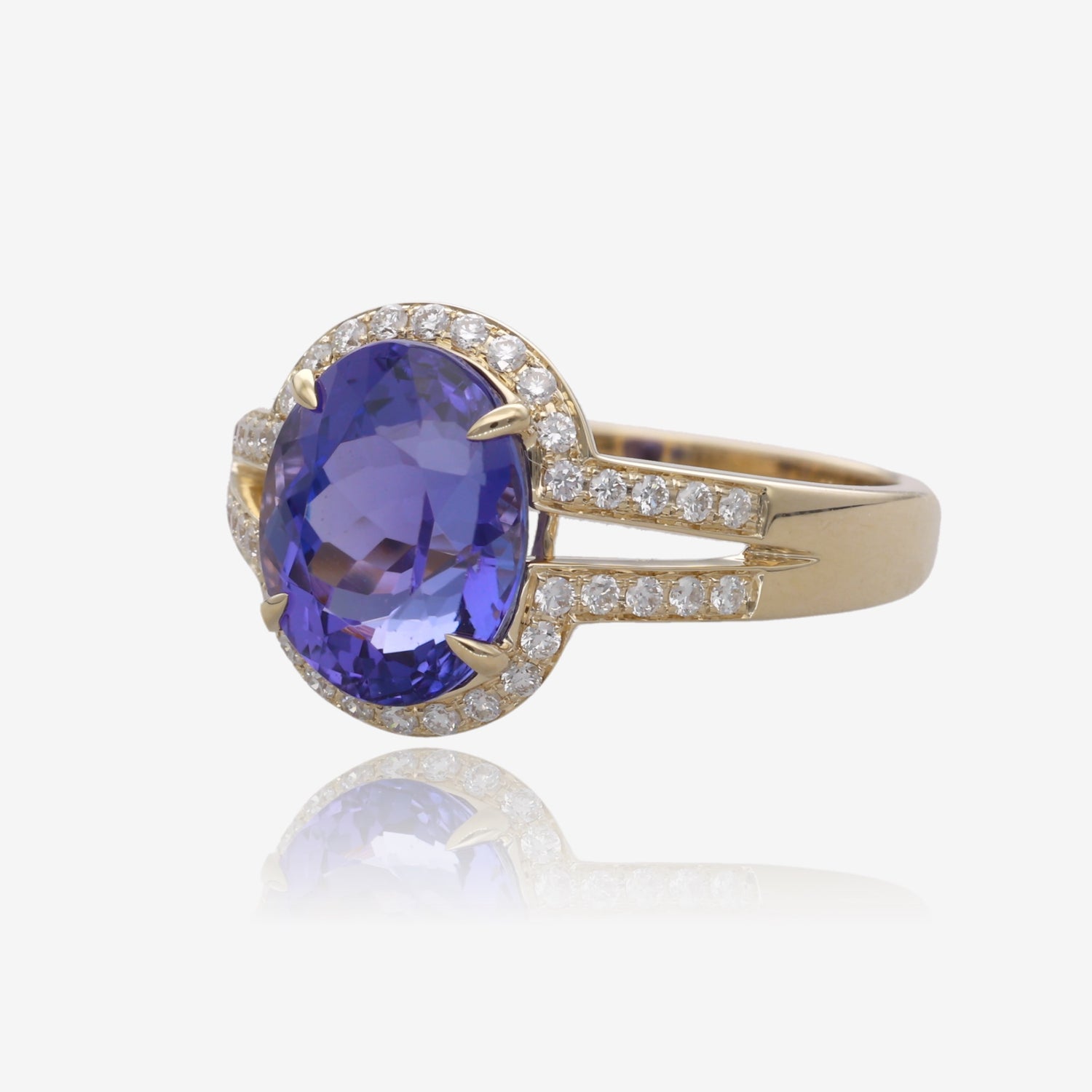 Royal Radiance: Yellow Gold Oval Tanzanite Ring with Diamond Accents