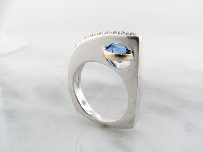 Blue topaz ring in sterling silver with topaz and white sapphire with 14k yellow gold.