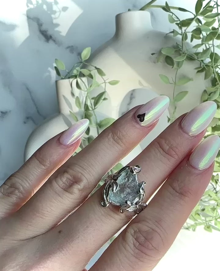 Video of hand modeling a pale blue aquamarine asymmetrical silver ring 