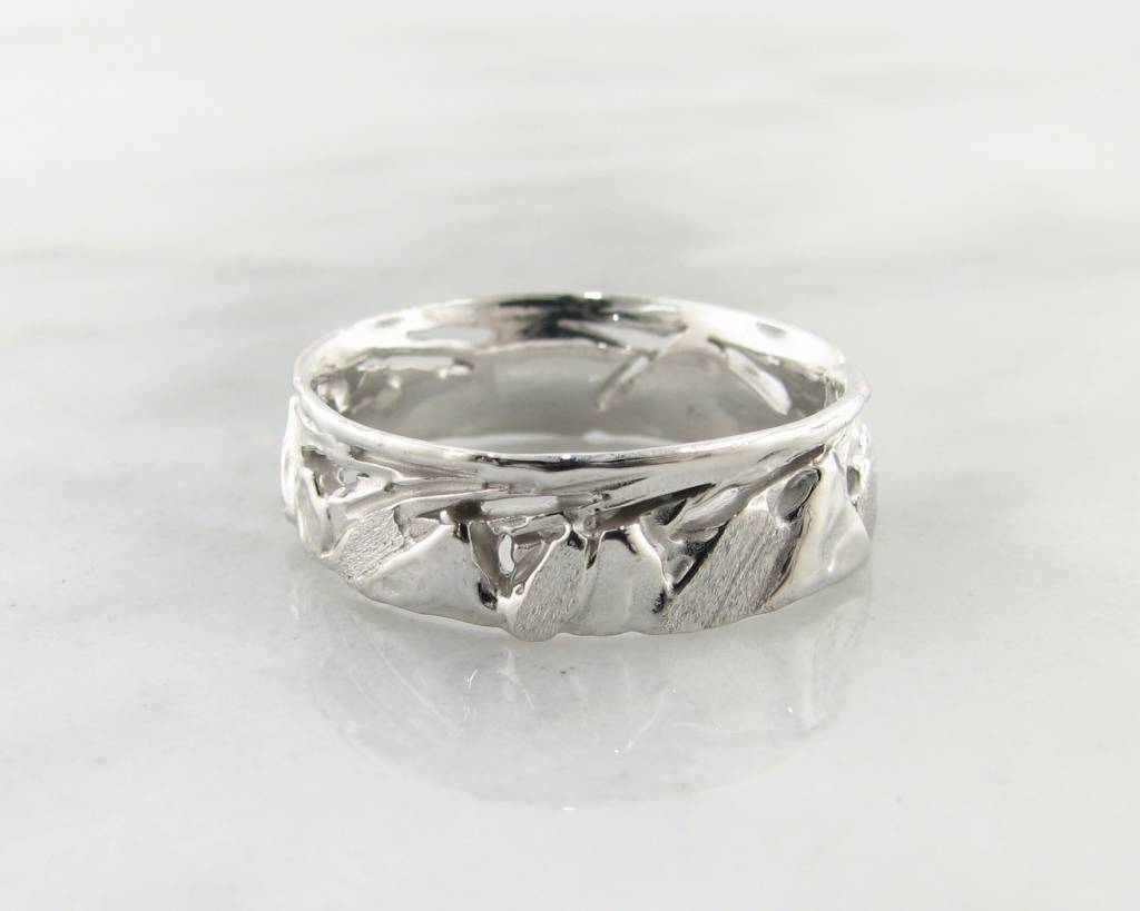 IMAGE SHOWS 6MM WIDE silver band with jagged mountain peaks sculpted all around. Ring is rustic with a rounded inside and rolled edges